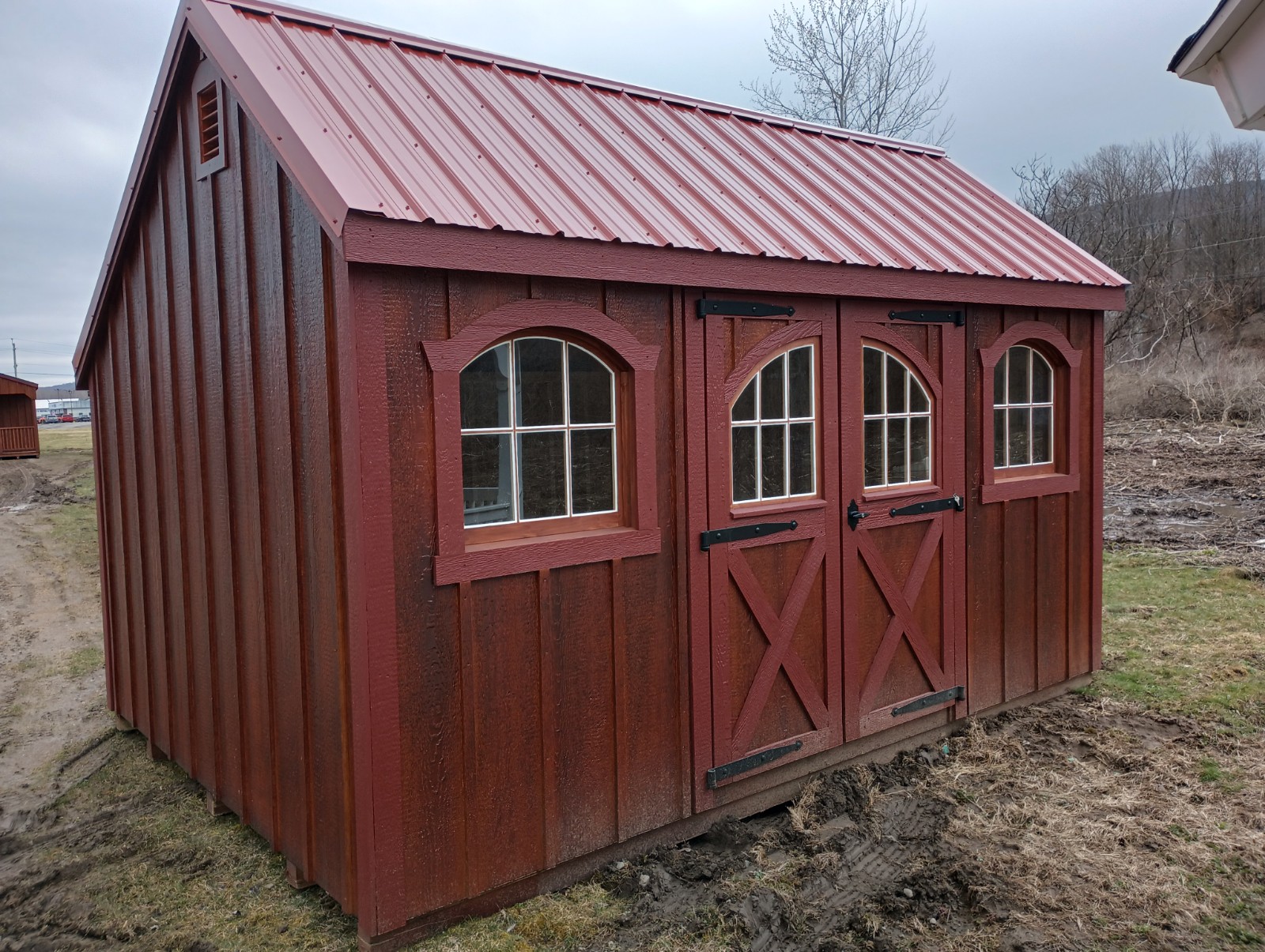 Shed with Stained B&B Siding and Arched Windows and Doors