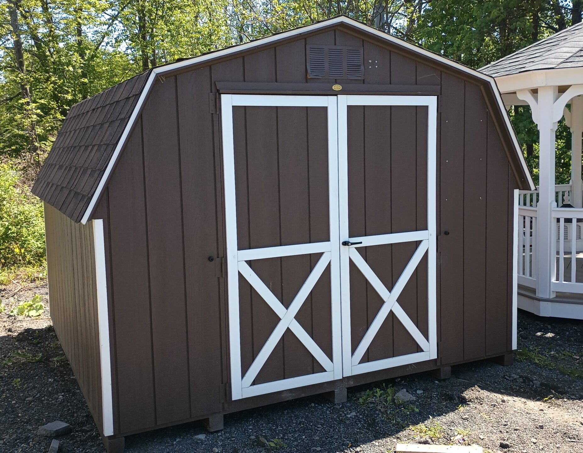Small Brown Shed with White Trim
