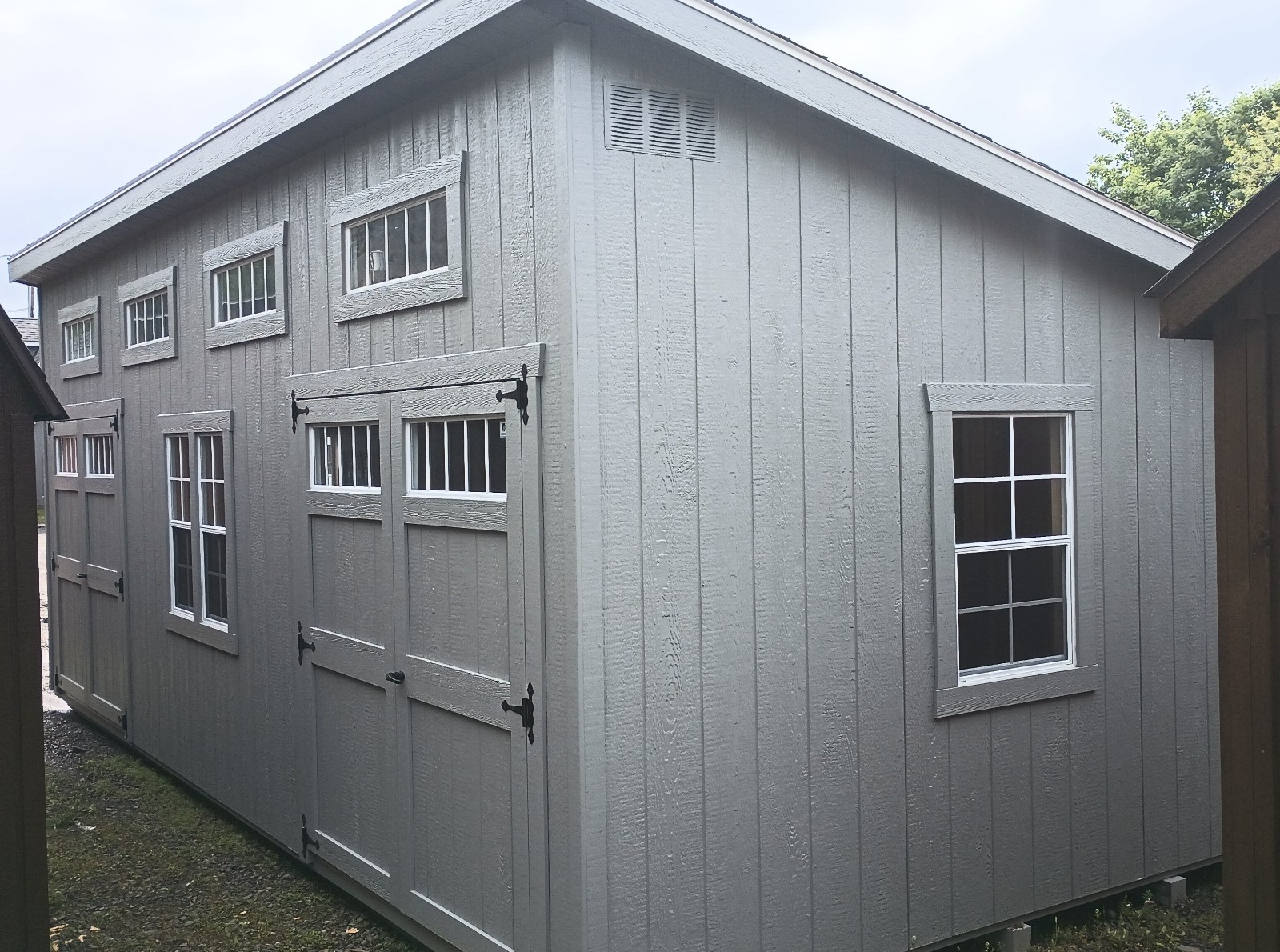 Grey Shed with Double Doors and Lots of Windows