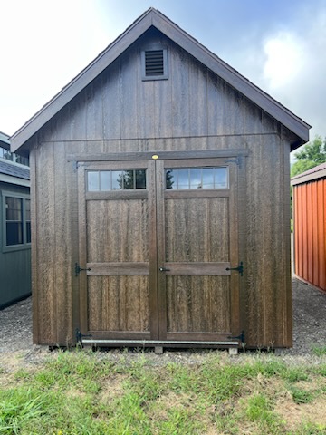 Mushroom stained shed with hinged roof double doors and windows with transom windows