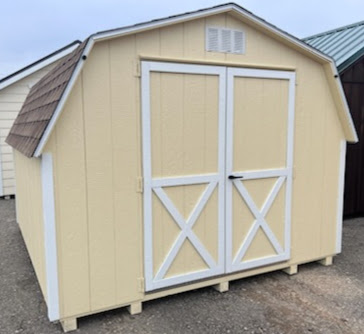 Small barn shed with double doors and shingled roof