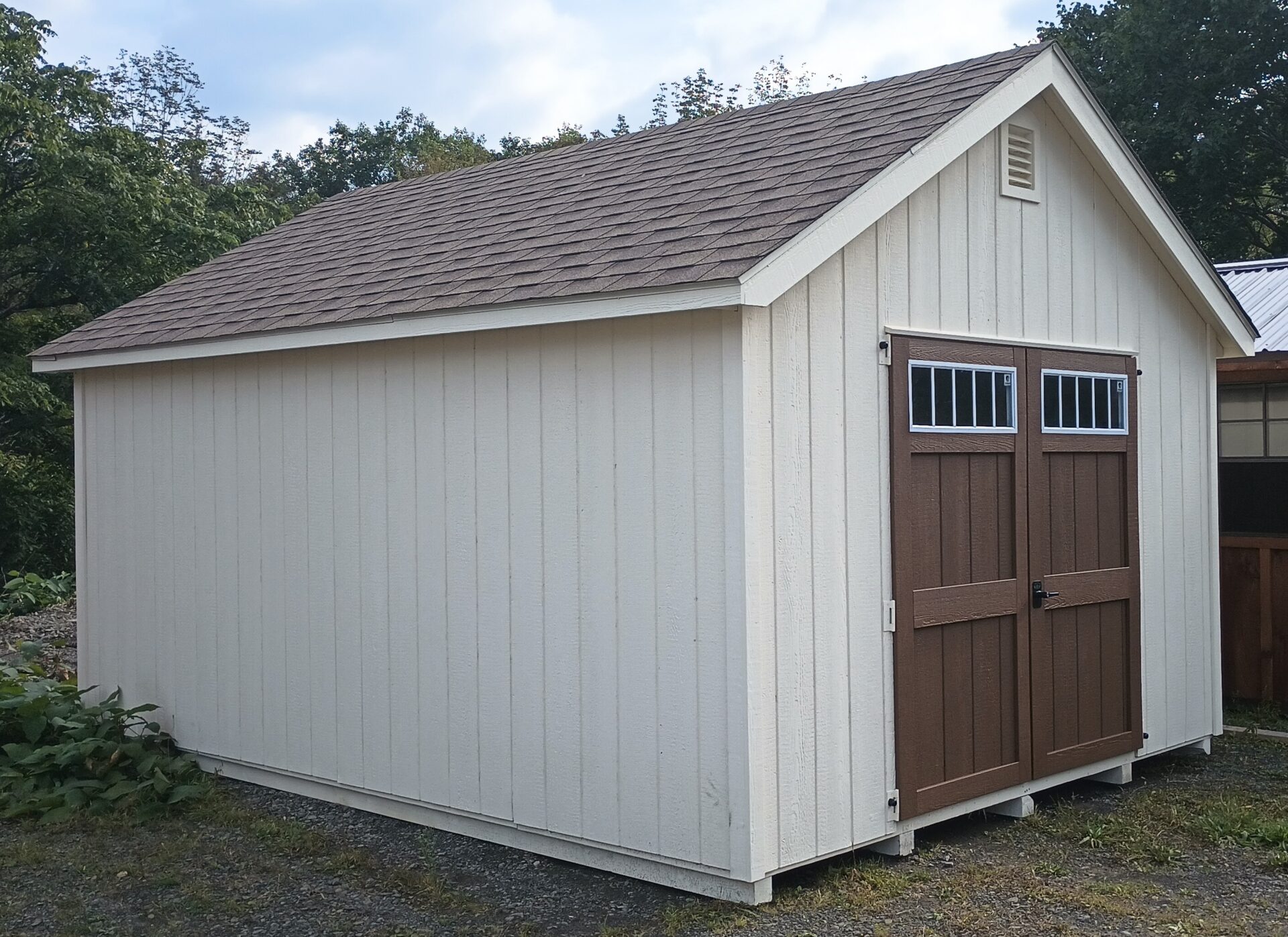 Cream color shed with brown doors