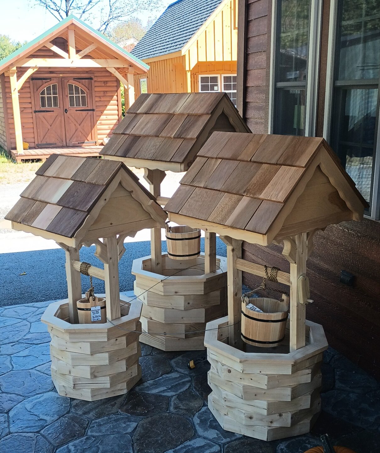 Wooden wishing wells of different sizes