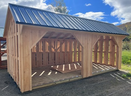 Firewood shed with two openings and slat siding