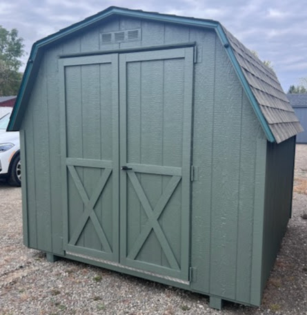 Avocado painted shed with double doors and shingles