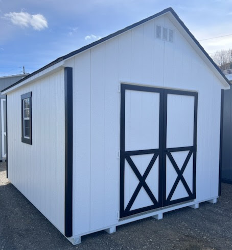 White shed with black trim double doors and two windows