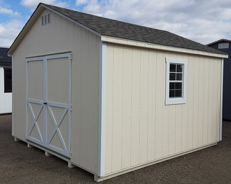 Cream color shed with white trim double doors and two windows
