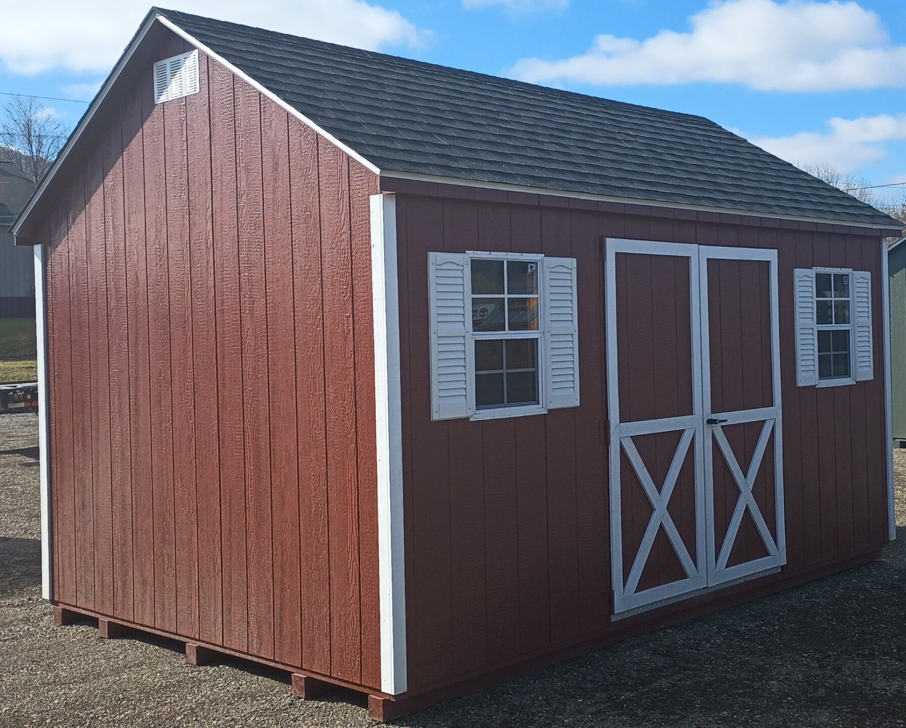 Red cape cod with shingles, double doors, 2 windows with shutters on eave