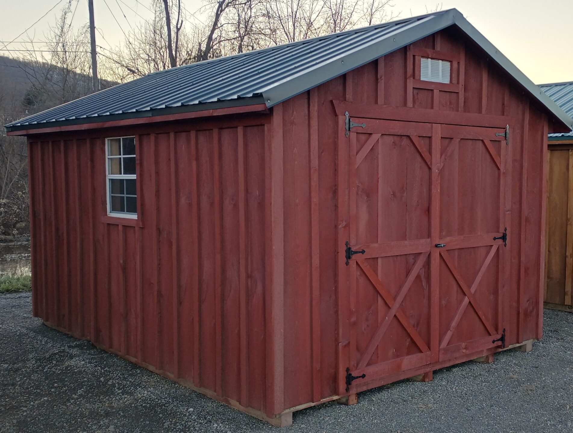 Board and batten shed with double doors metal roof and two windows