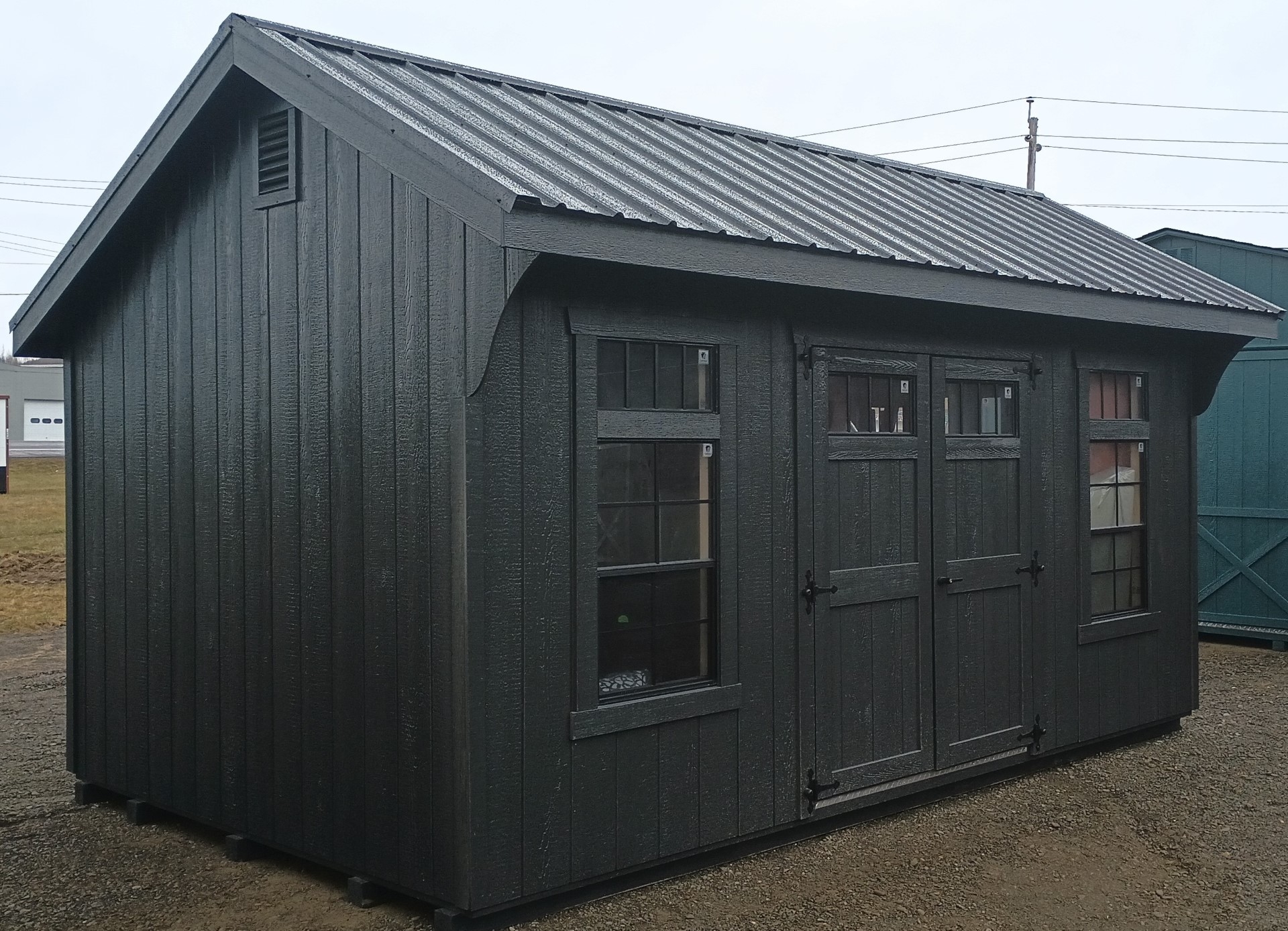 Green/Black carriage style shed with double doors and 2 windows