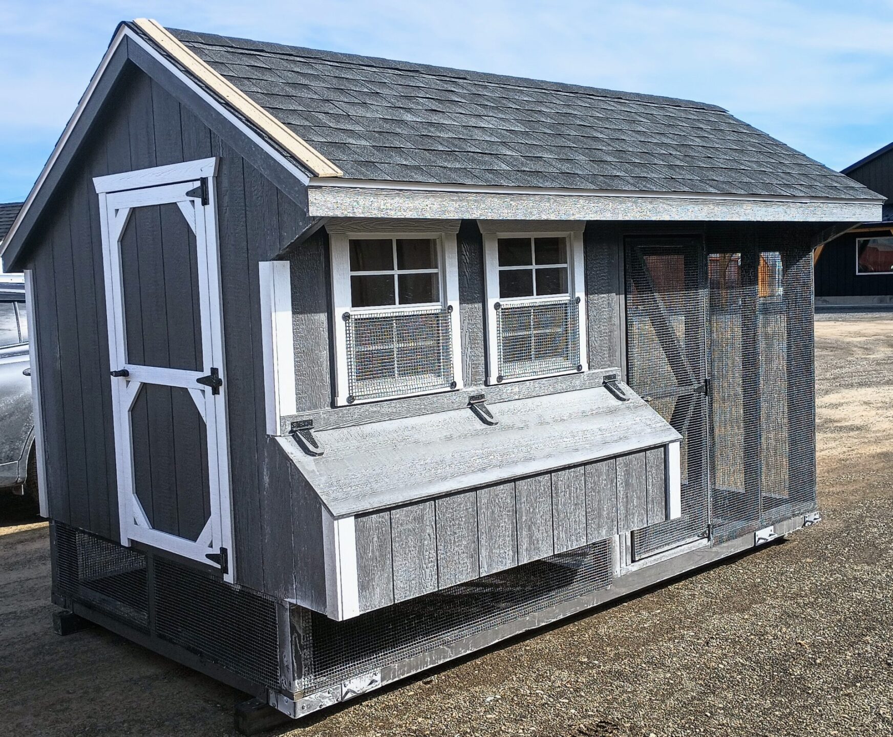 Dark gray combination coop with white trim, entry door, 2 windows and nesting boxes