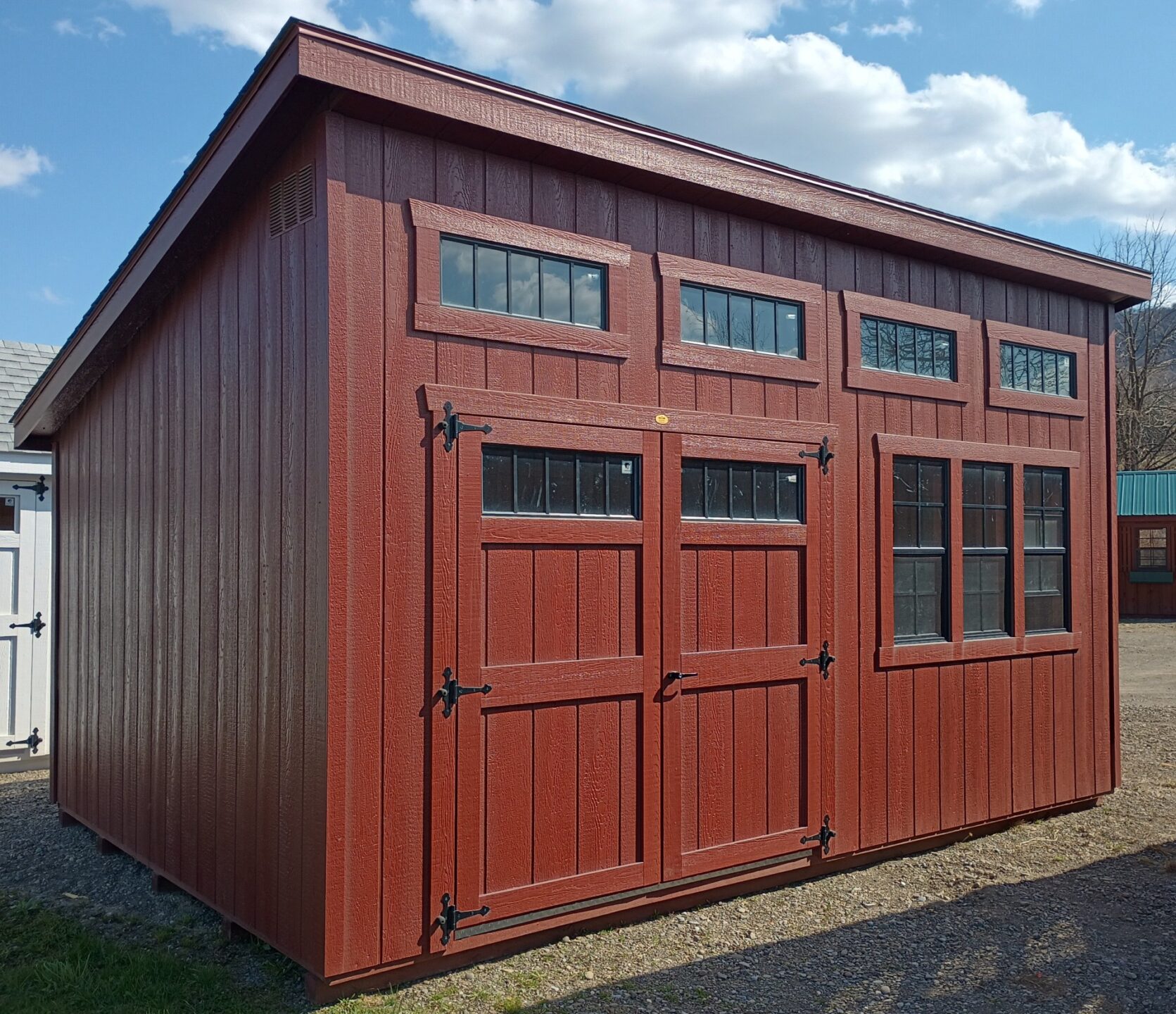Red one slant shed with three windows, transom windows and double doors with transom windows