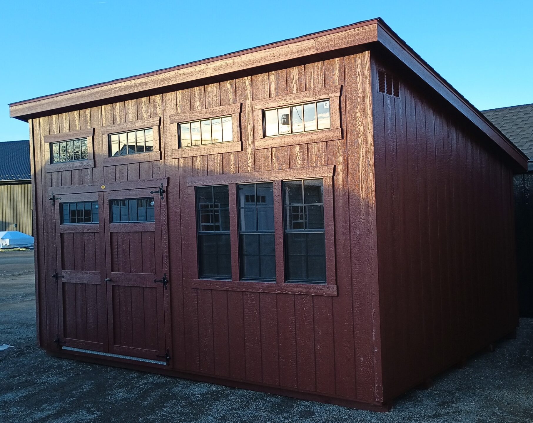 Red one slant shed with three windows, transom windows and double doors with transom windows