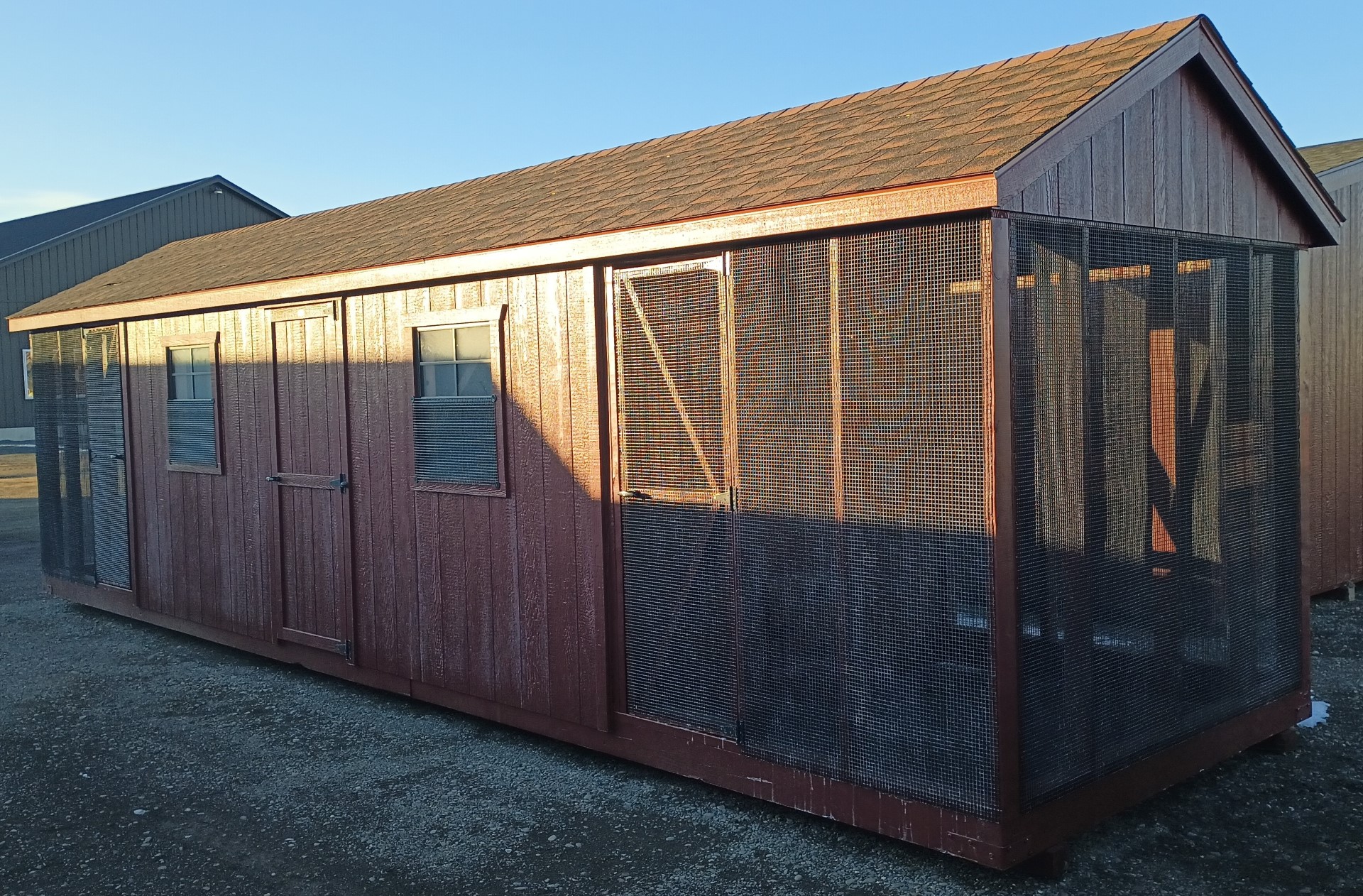 Large chicken combination coop with run areas on either end, center door, and 3 windows