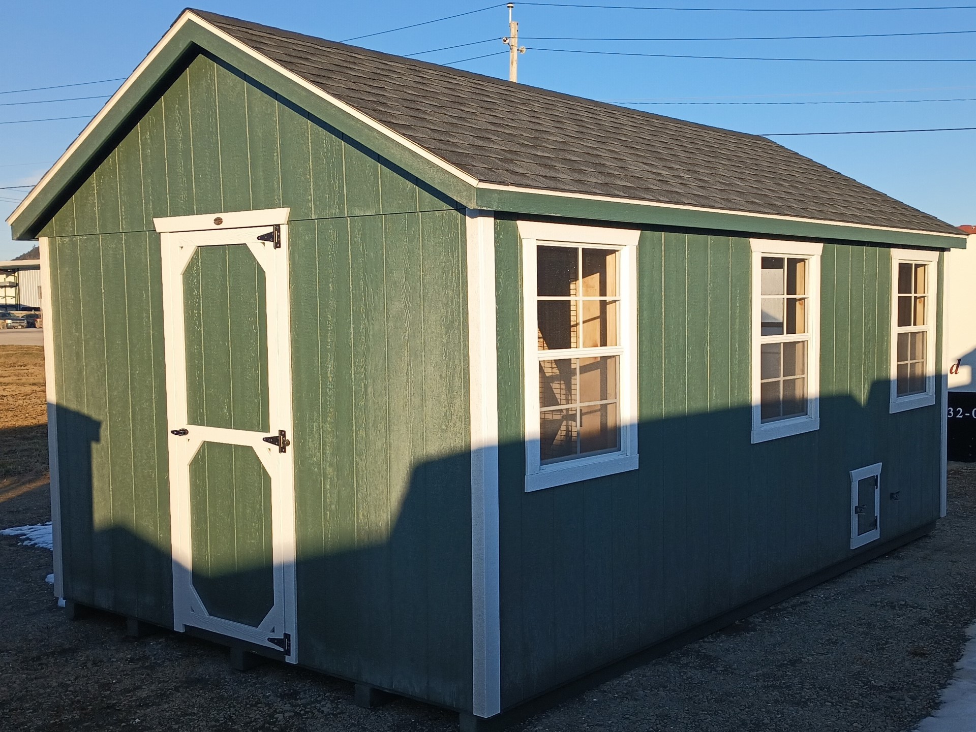 Green a frame chicken coop with outside door and 3 windows, bars, boxes and storage area all located inside main door