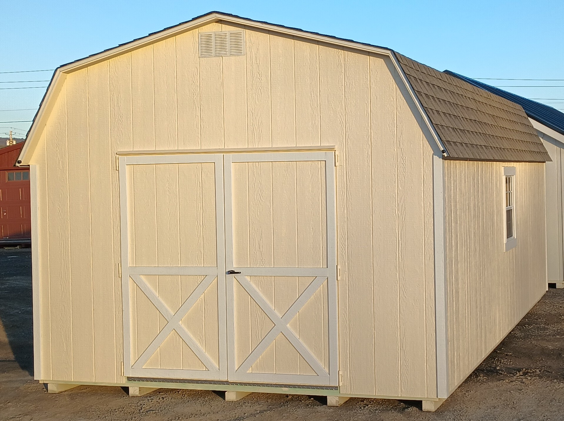 Wall barn with off white color and white trim with double doors and 2 windows