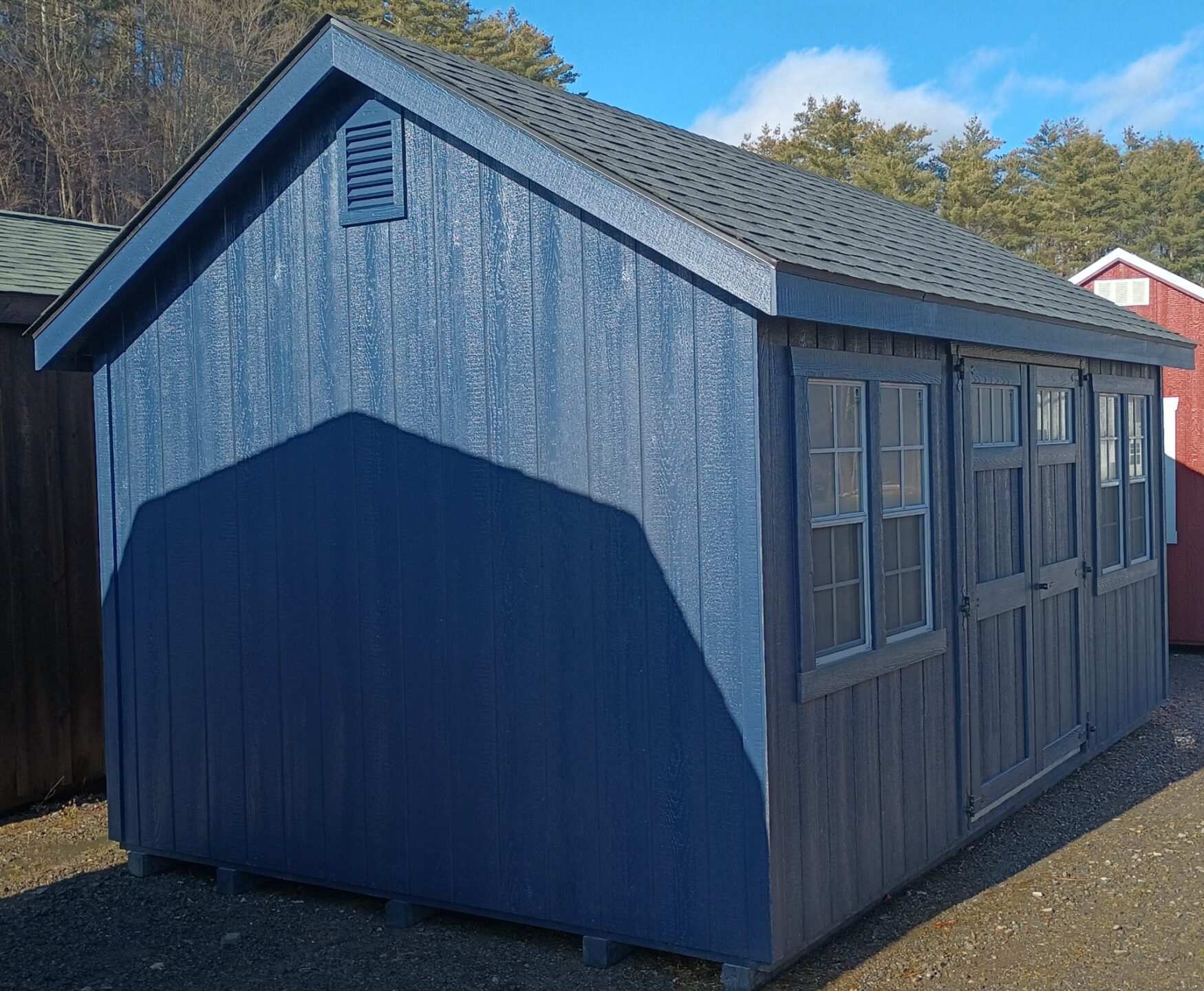 Naval color shed with double doors and 4 windows on front wall
