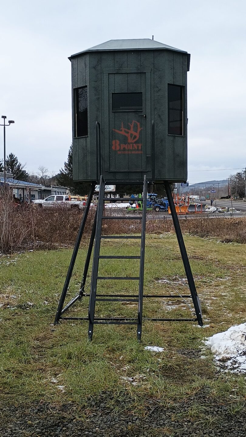 Metal adjustable stand with hunting blind on top