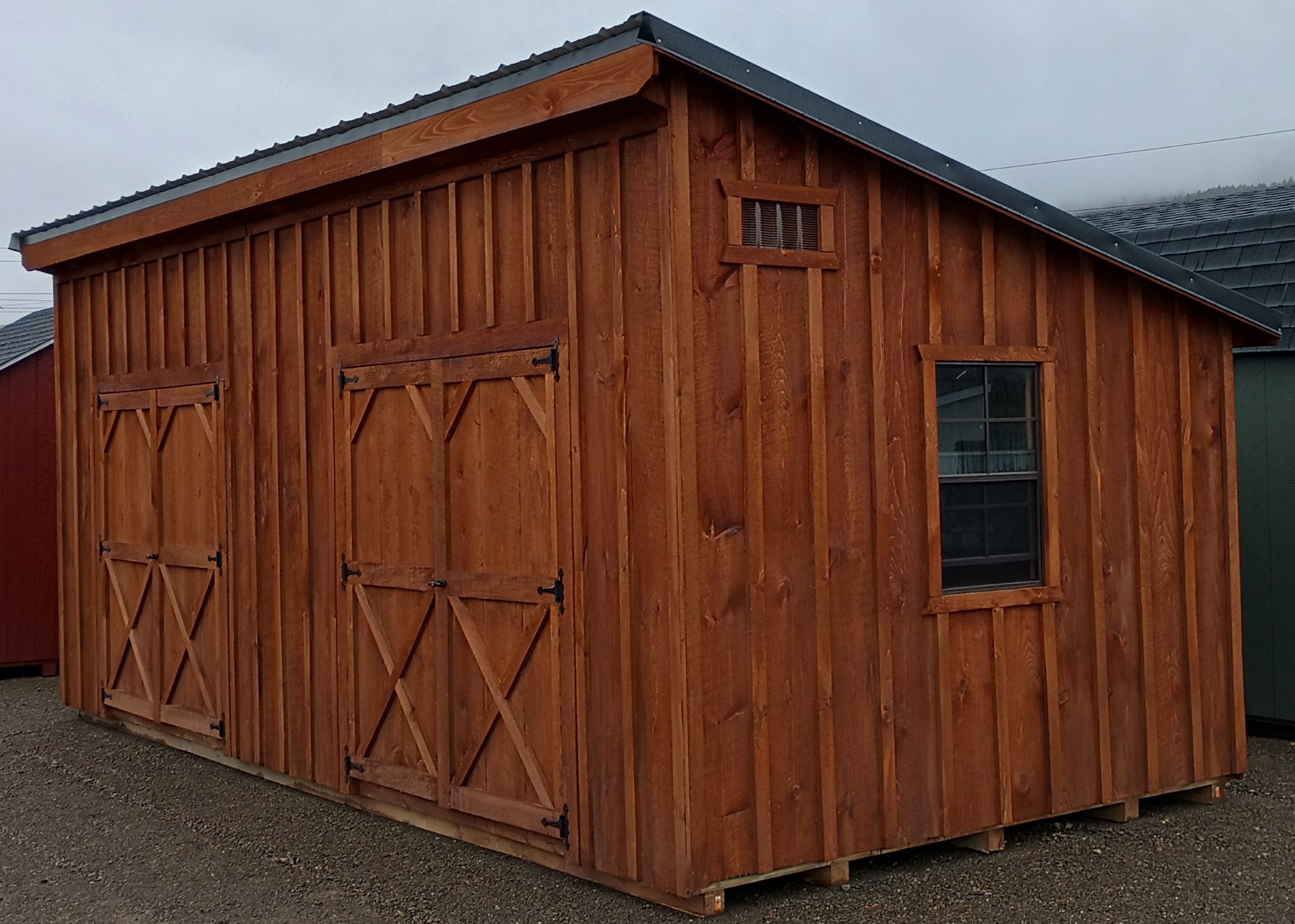 Large one slant building with board & batten siding and two sets of double doors