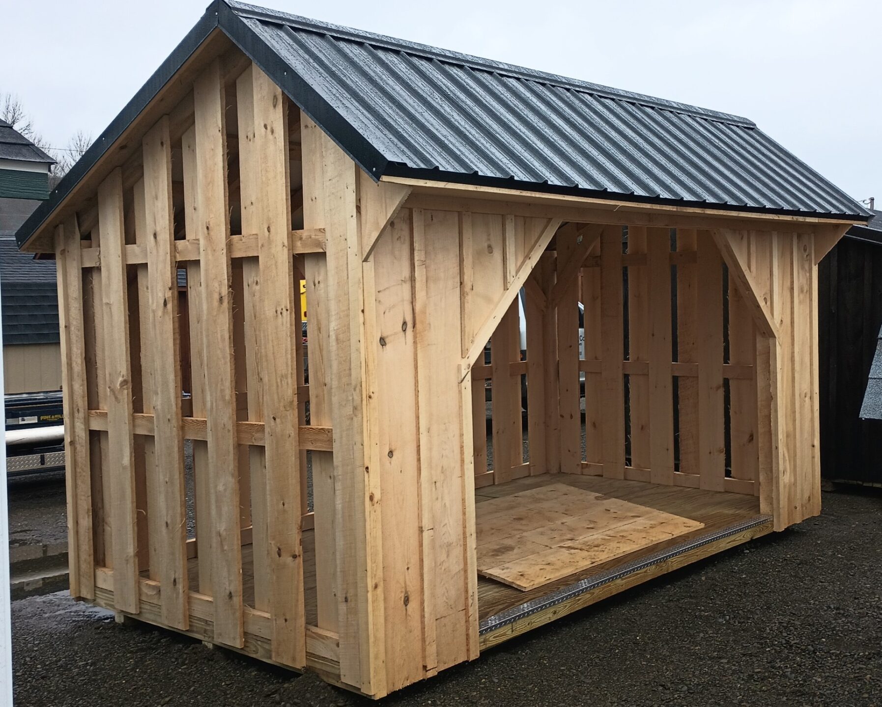 3 Sided wood shed with metal roof and ramp for opening