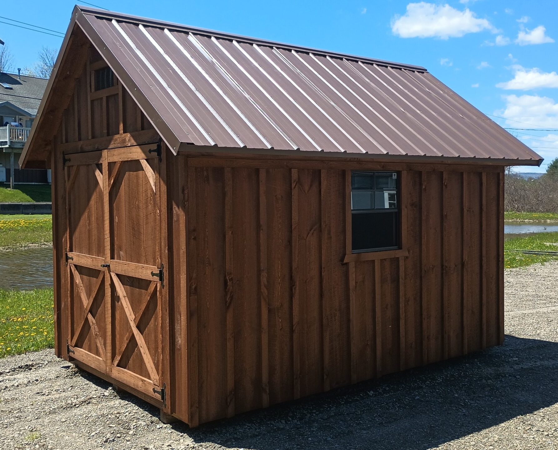 Cape Cod roofline shed with double doors and brown metal roof