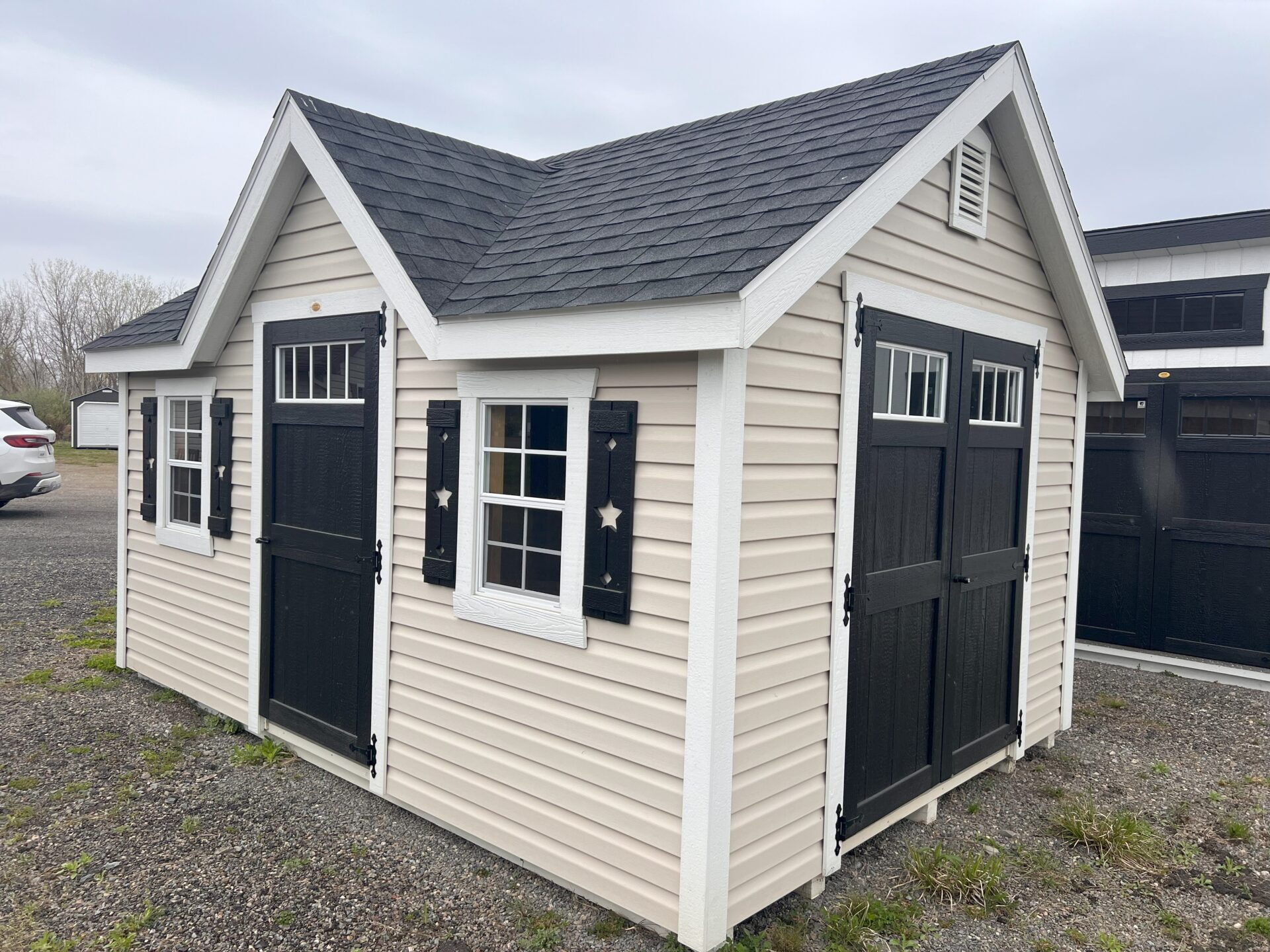 Vinyl shed with double and single doors, 2 windows and peak dormer