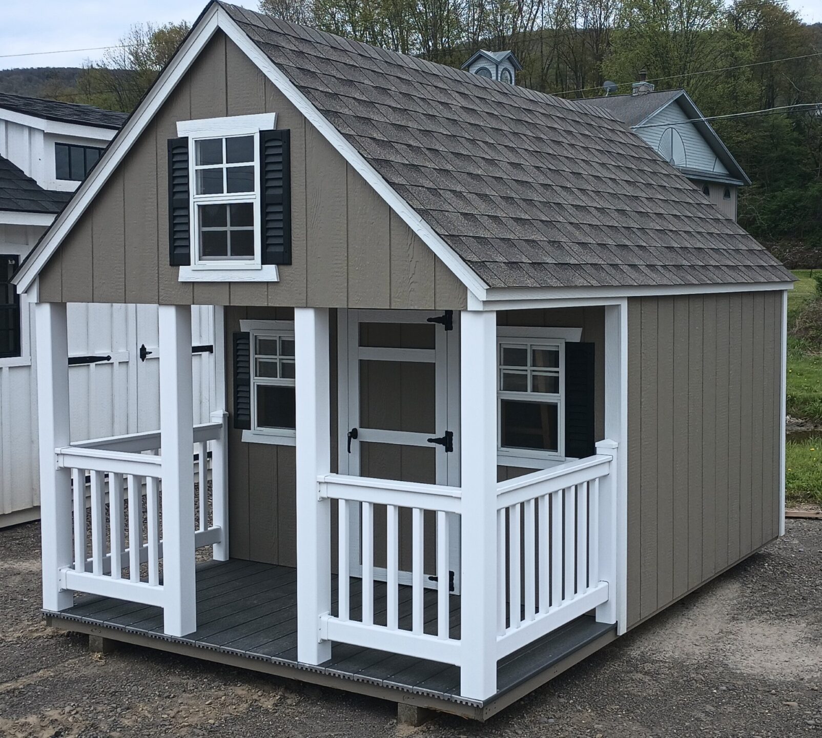 Clay and white playhouse with white vinyl porch, single door and windows
