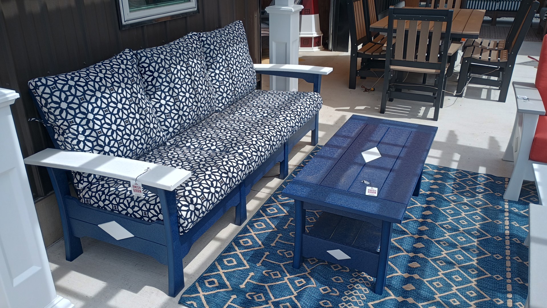 Blue and White poly couch with blue and white cushions and blue poly coffee table