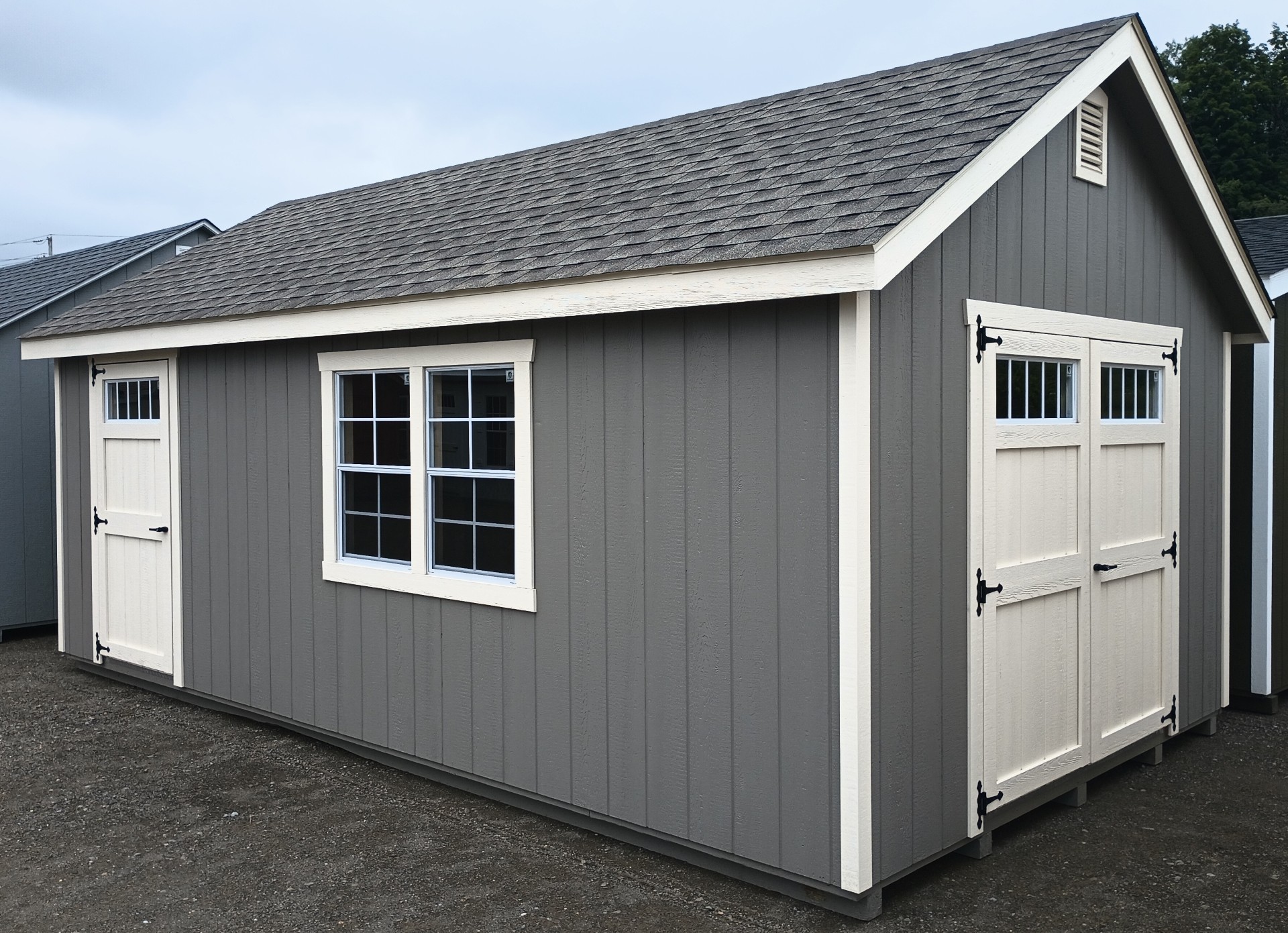 Shed with double doors, single door and 3 windows and shingled roof