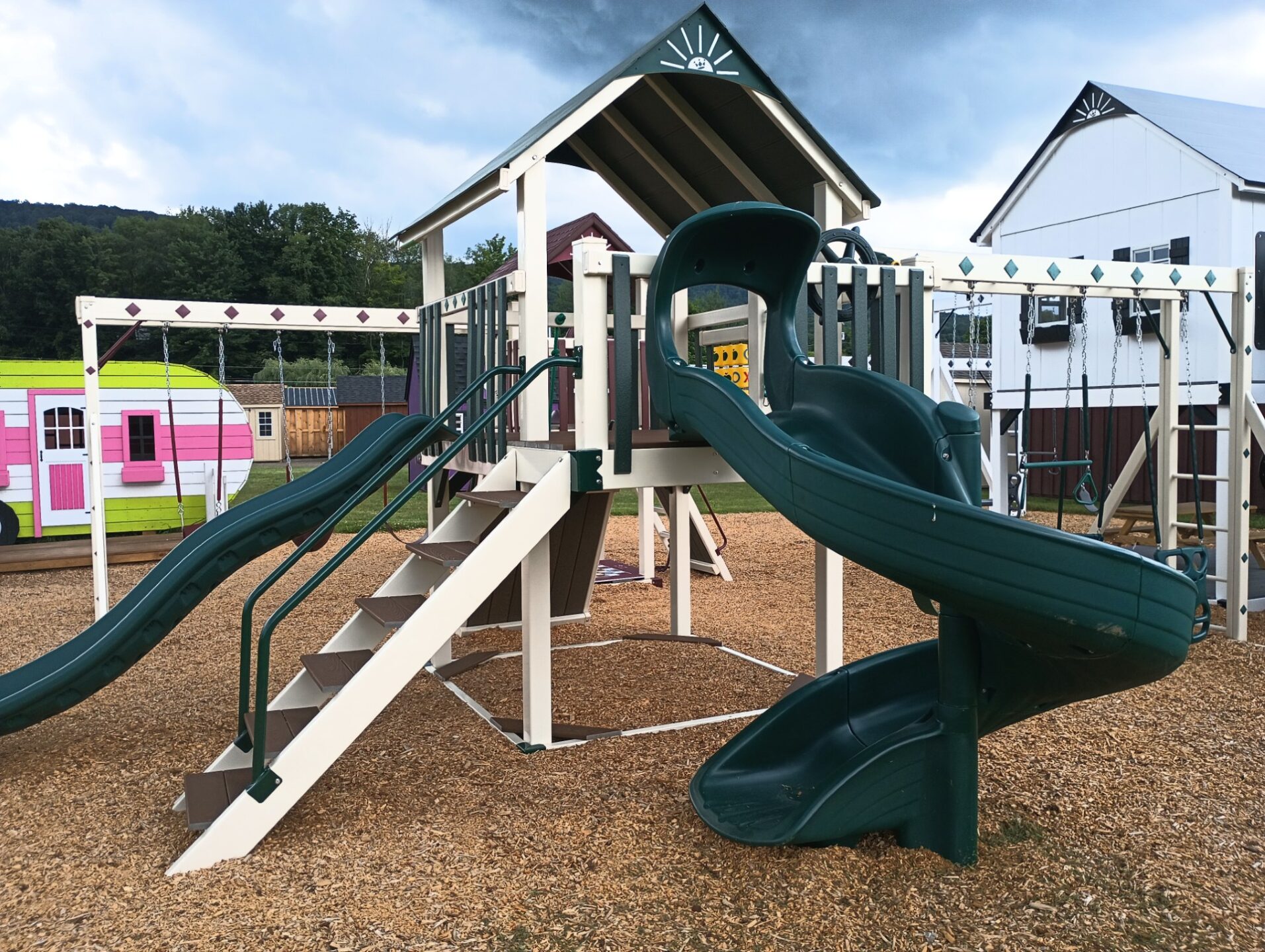 Vinyl swing set with rock wall and slides