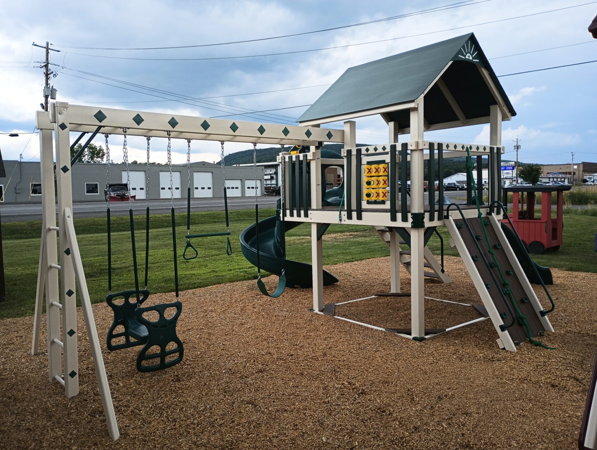 Vinyl swing set with rock wall and slides