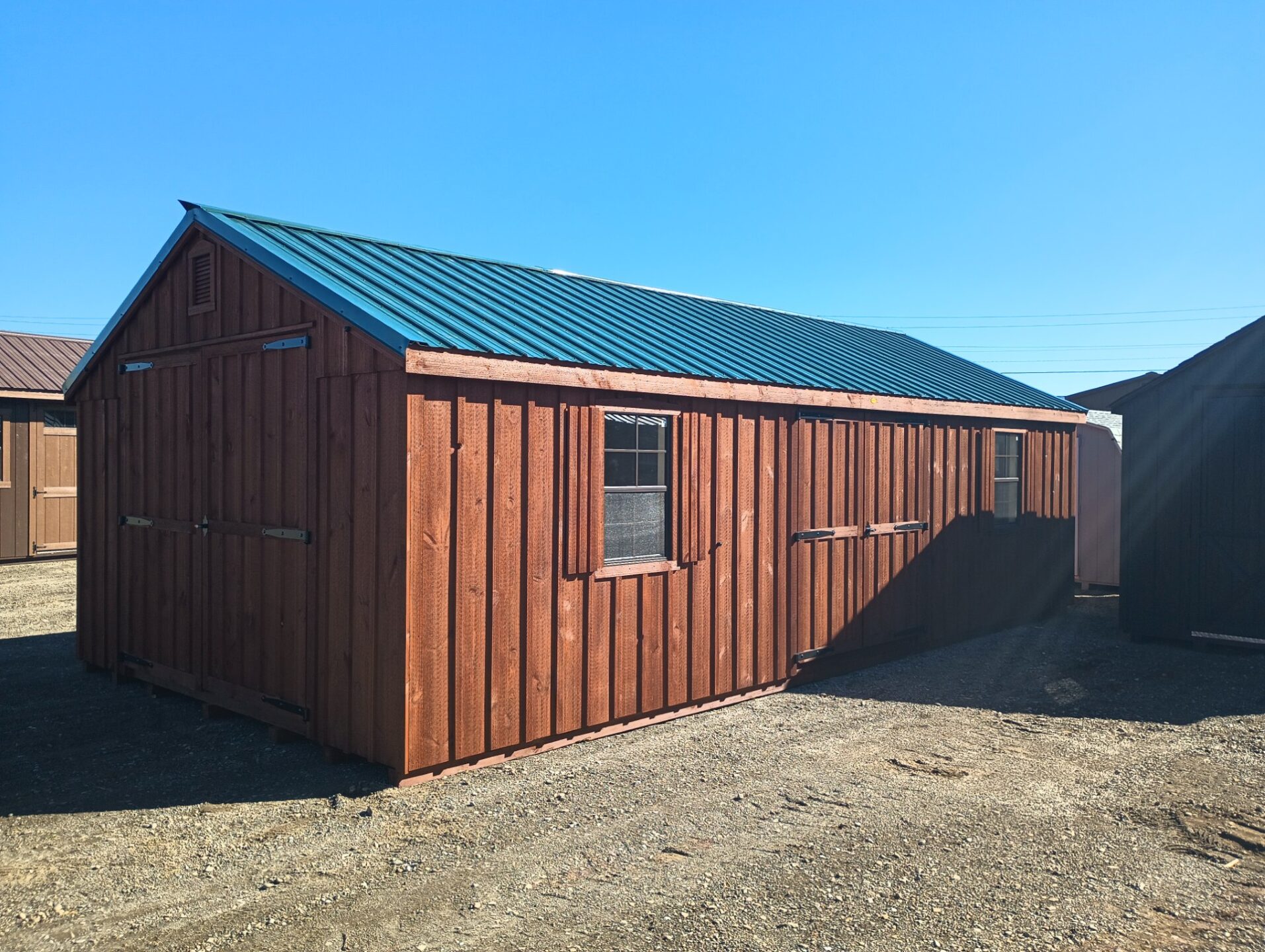 Large board and batten shed with metal roof and two sets of double doors