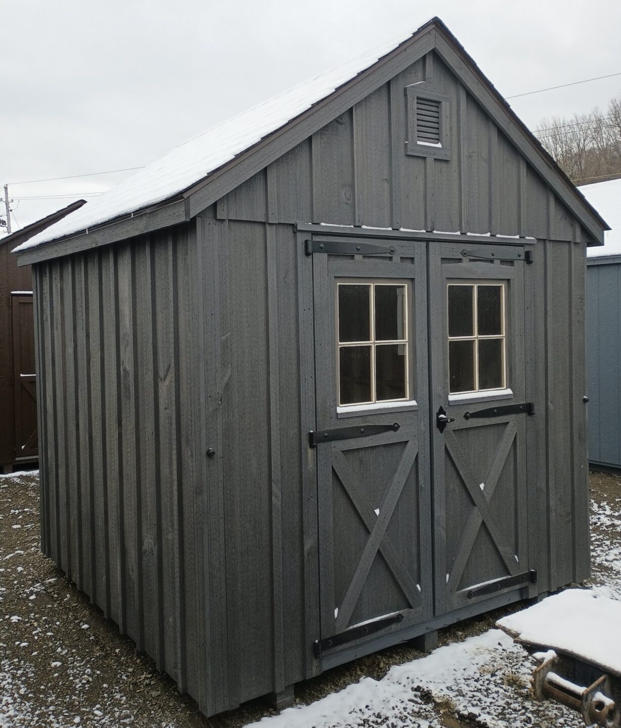 Small board and batten shed with double doors with windows