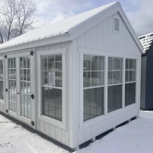 Custom greenhouse built by Amish Barn Company surrounded by snow in the winter