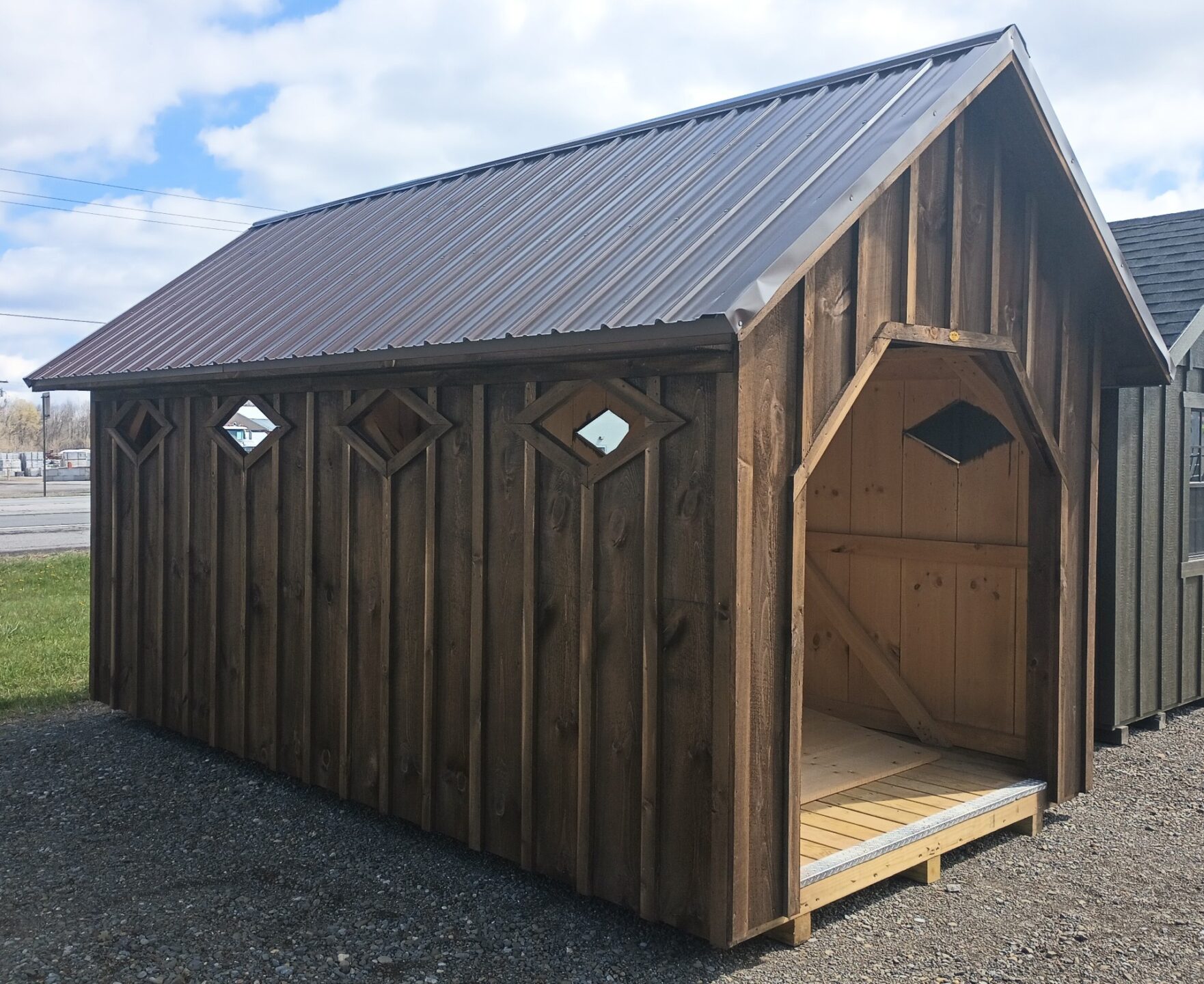 Steep roof pitch with openings at either end and diamond shaped windows along each side