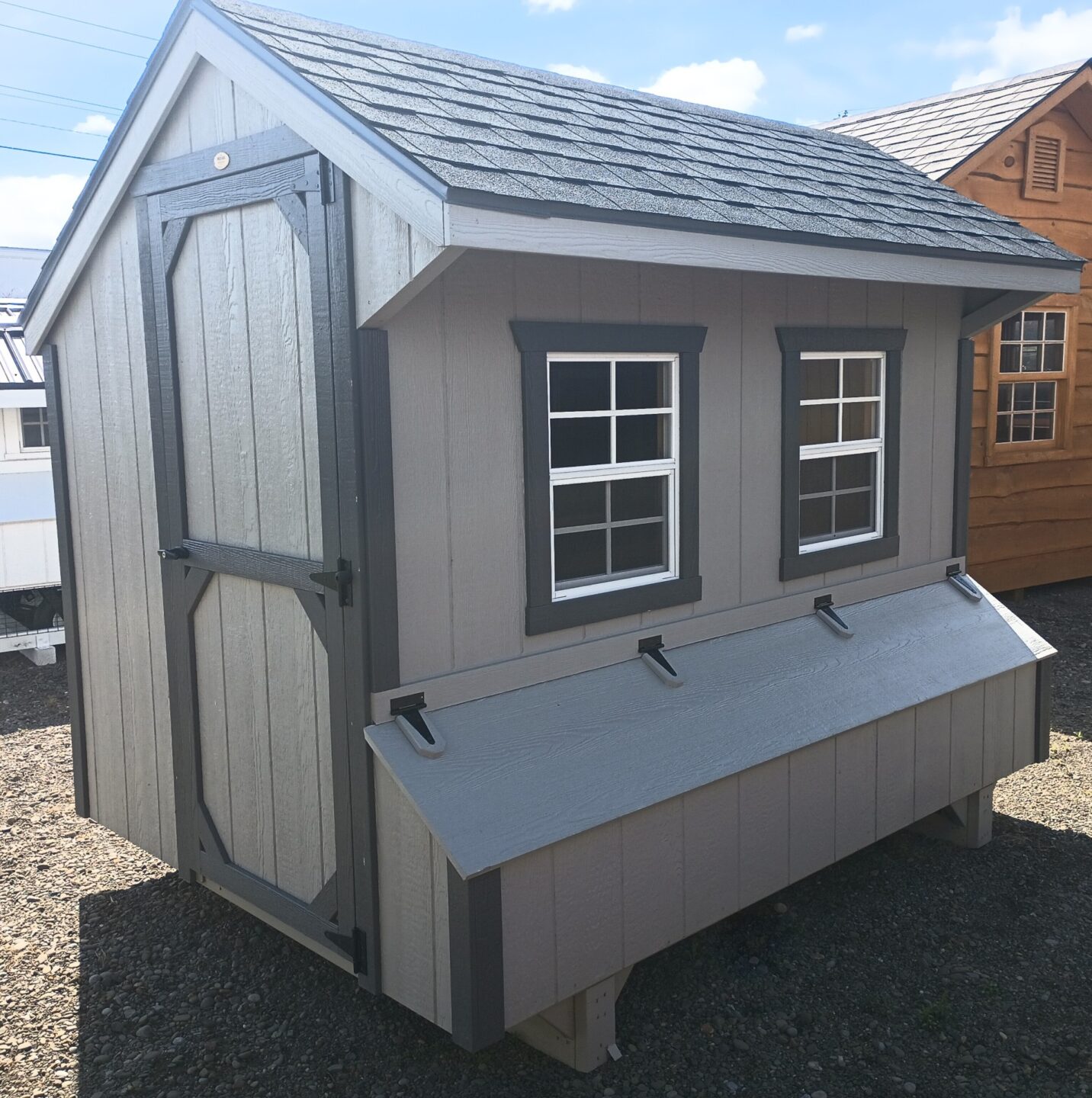 Quaker style coop in light gray with dark gray trim, access door, nesting boxes and two windows