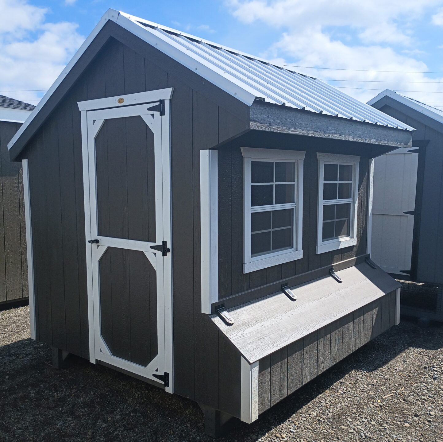 Small quaker coop with two windows, metal roof and nesting boxes