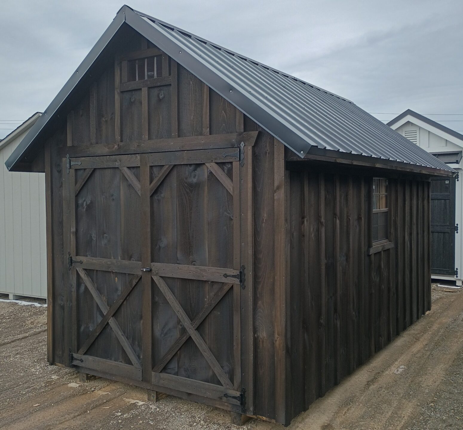 Dark stained Board and Batten Shed with Steeper metal roof and double doors