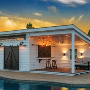 Custom-built pool house featuring bar counter and shaded seating area with a beautiful sunset backdrop