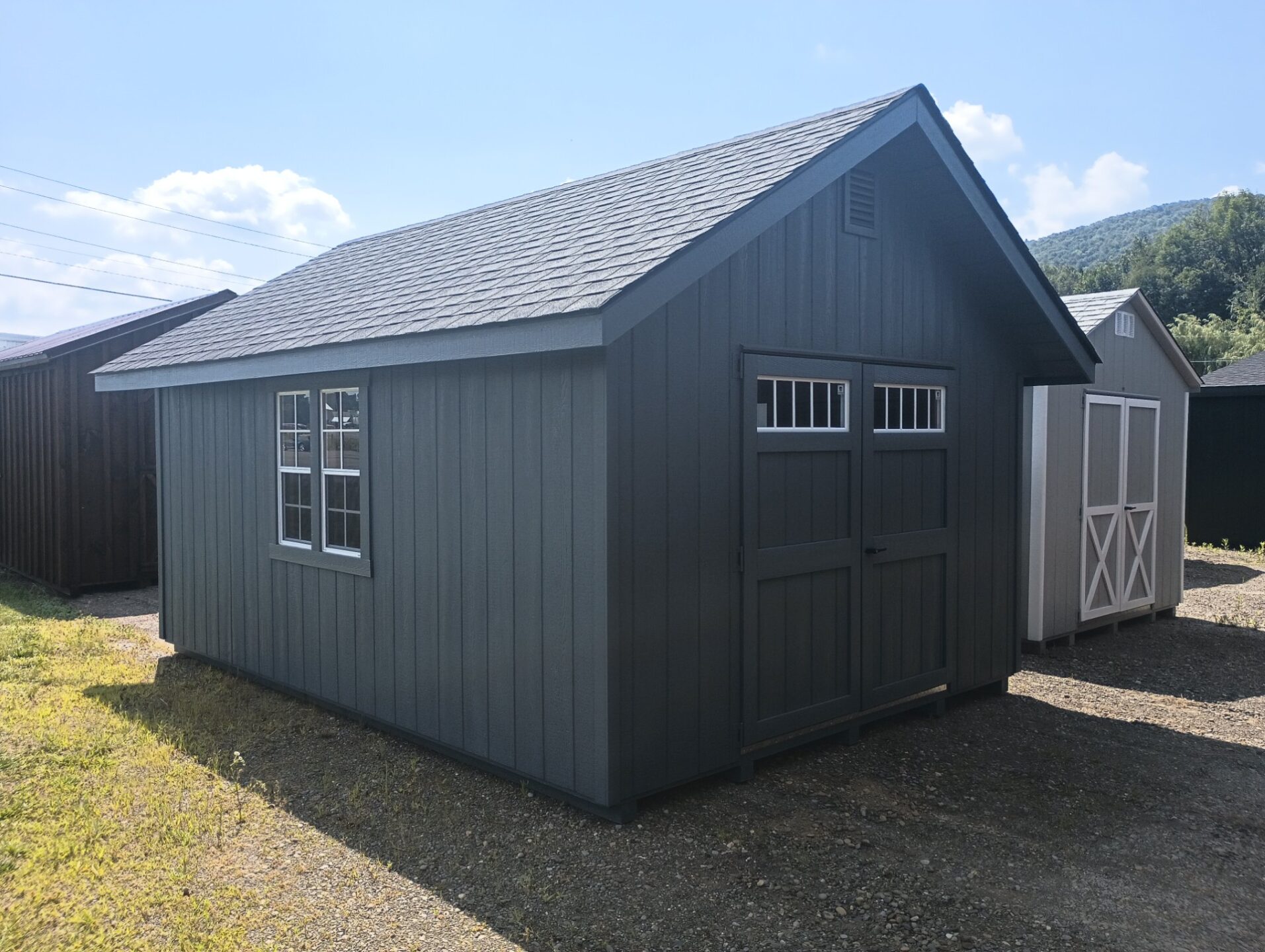 Shed with large overhangs, windows and double doors with transom windows