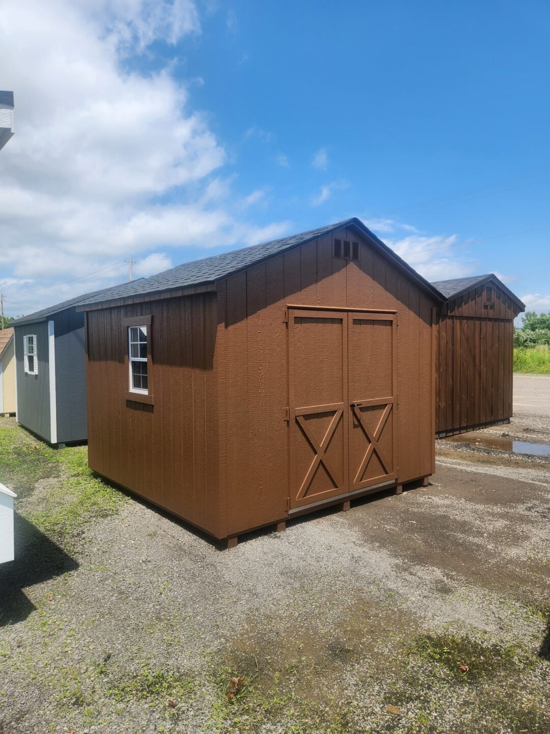 Chestnut color a frame shed with double doors on the front and a window on either side