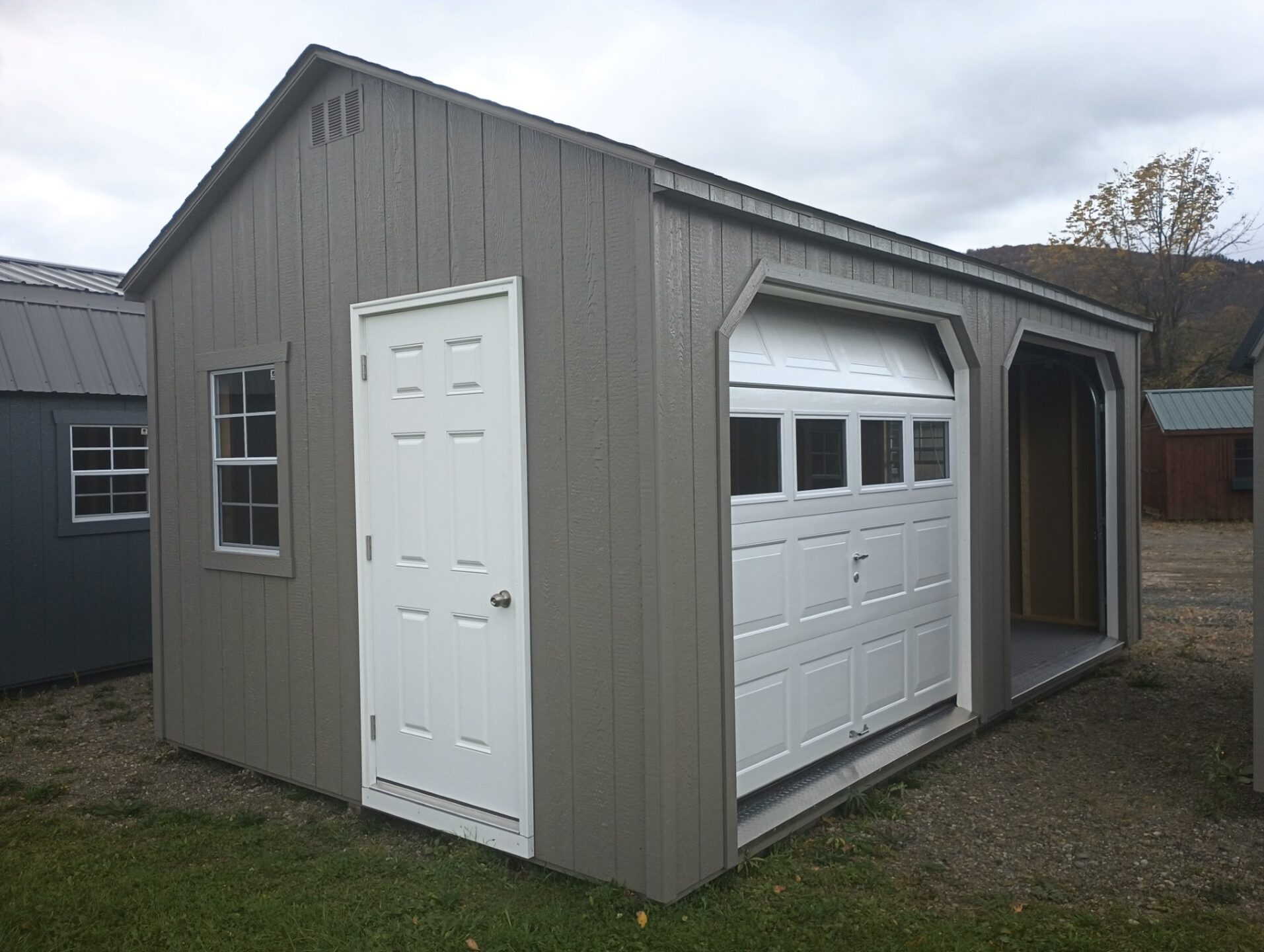 Shed with two garage doors on long side, with side door and windows