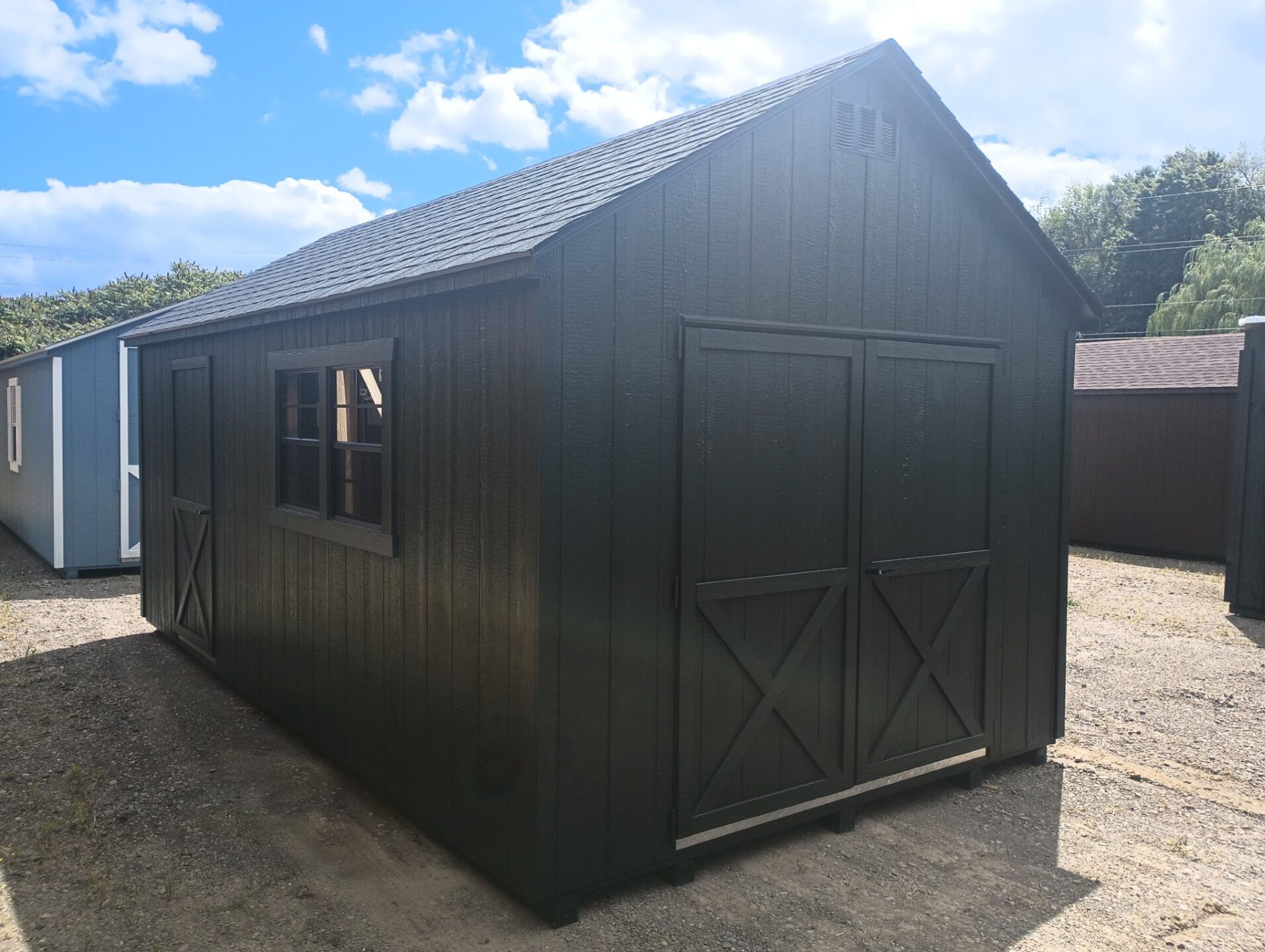 Shed with double doors, two windows and single door, shingled roof and window on other side