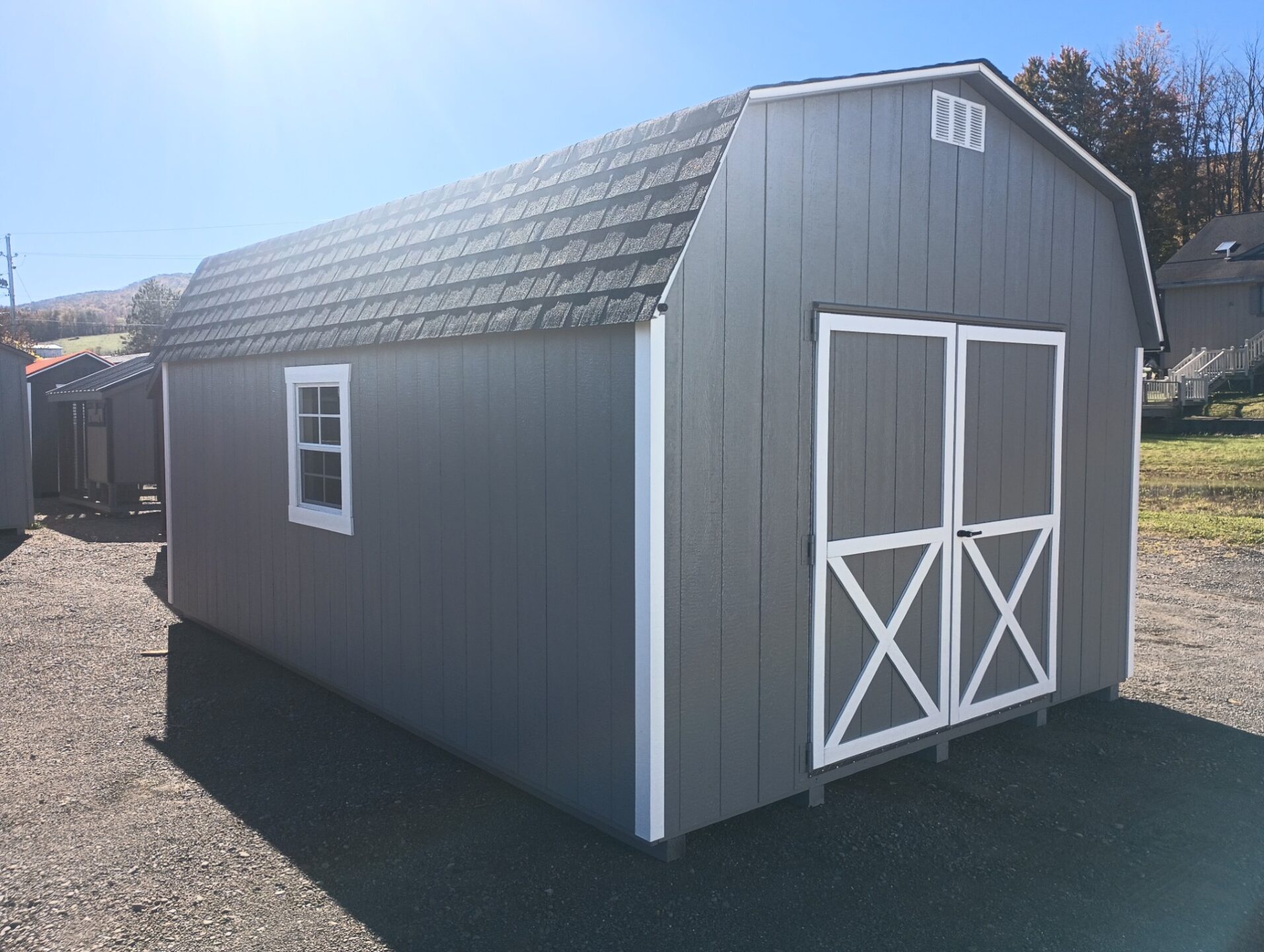 Barn style shed with double doors, gable vents and windows on either side