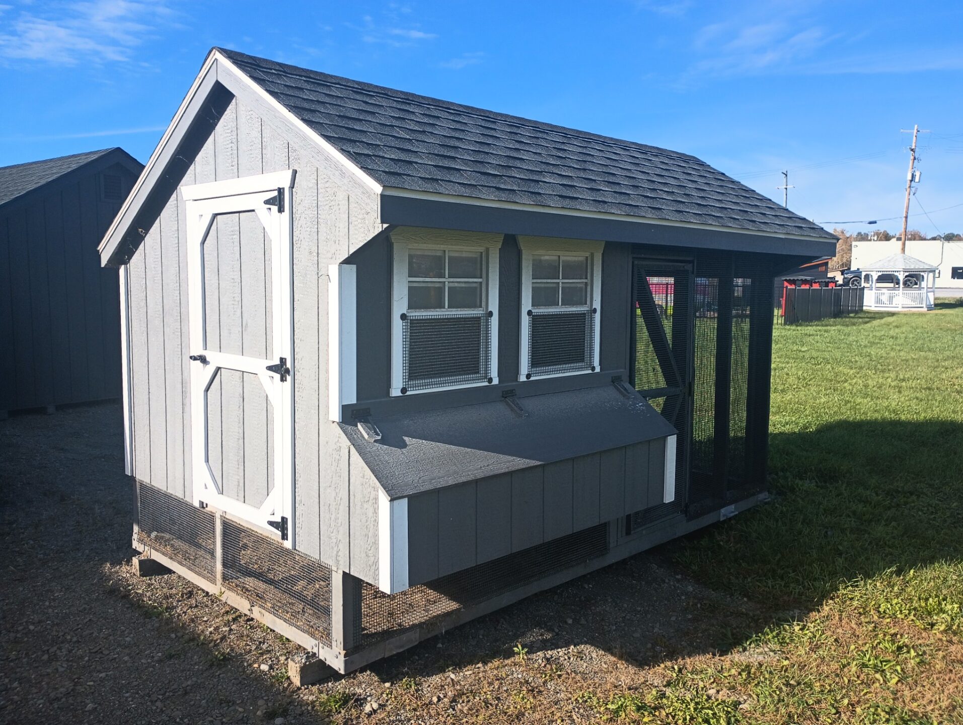 Chicken coop with single door, nesting boxes, two windows and run area on the side