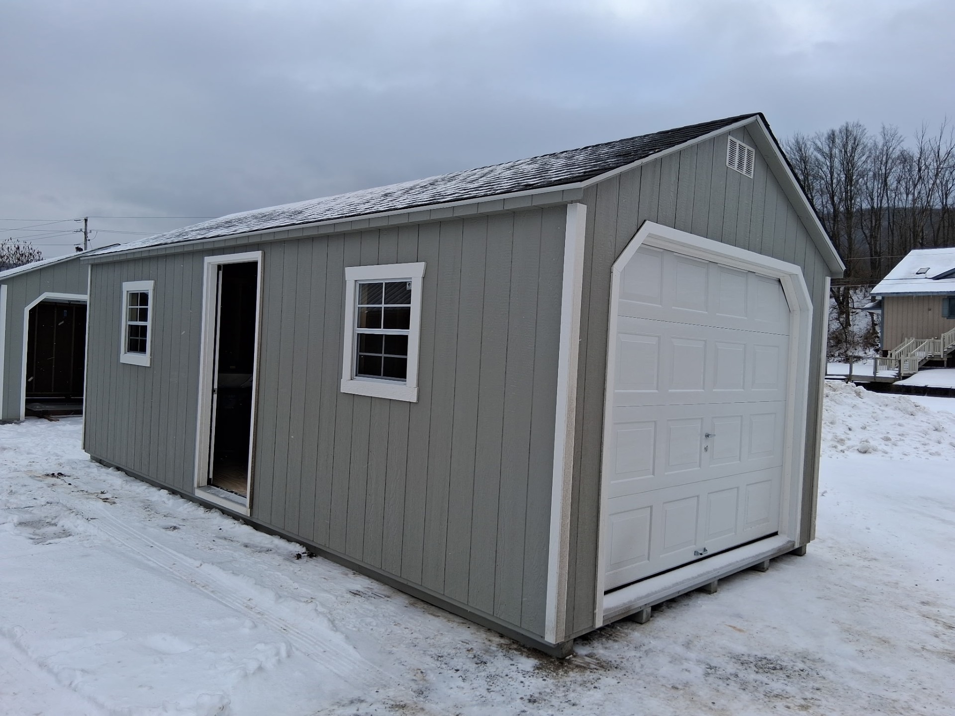 A Frame garage with overhead door (2) side windows and (1) single door