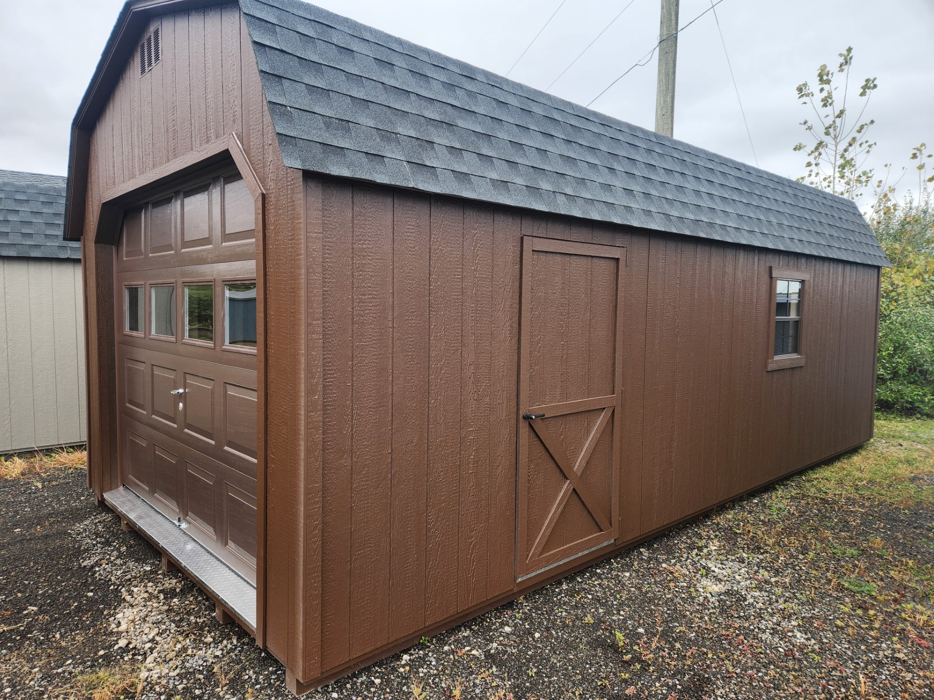 Barn style roof garage with overhead door with glass, side door, shingled roof and two windows