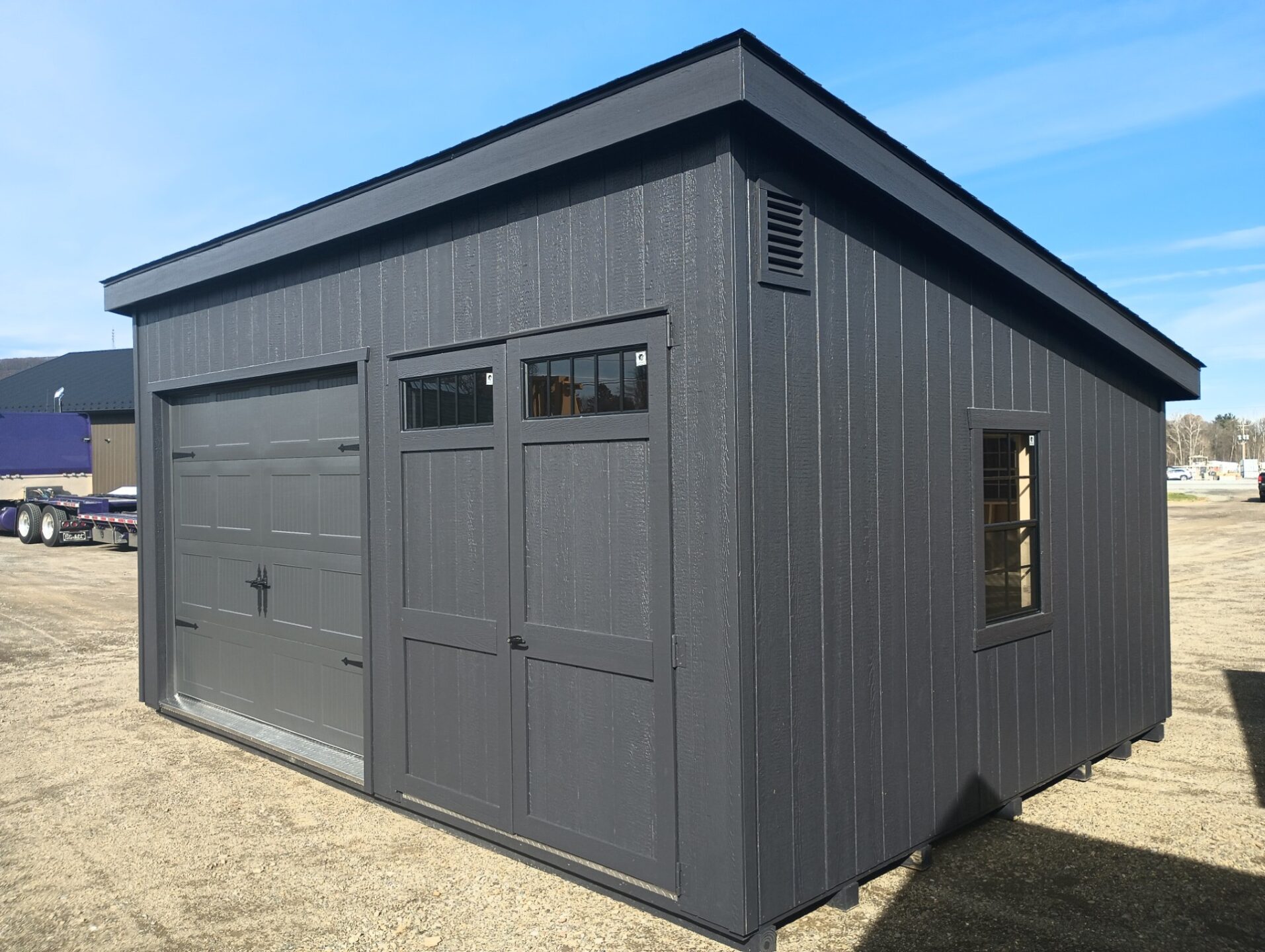 One slant shed style with overhead door and tall double doors on front with a window and vent on either end