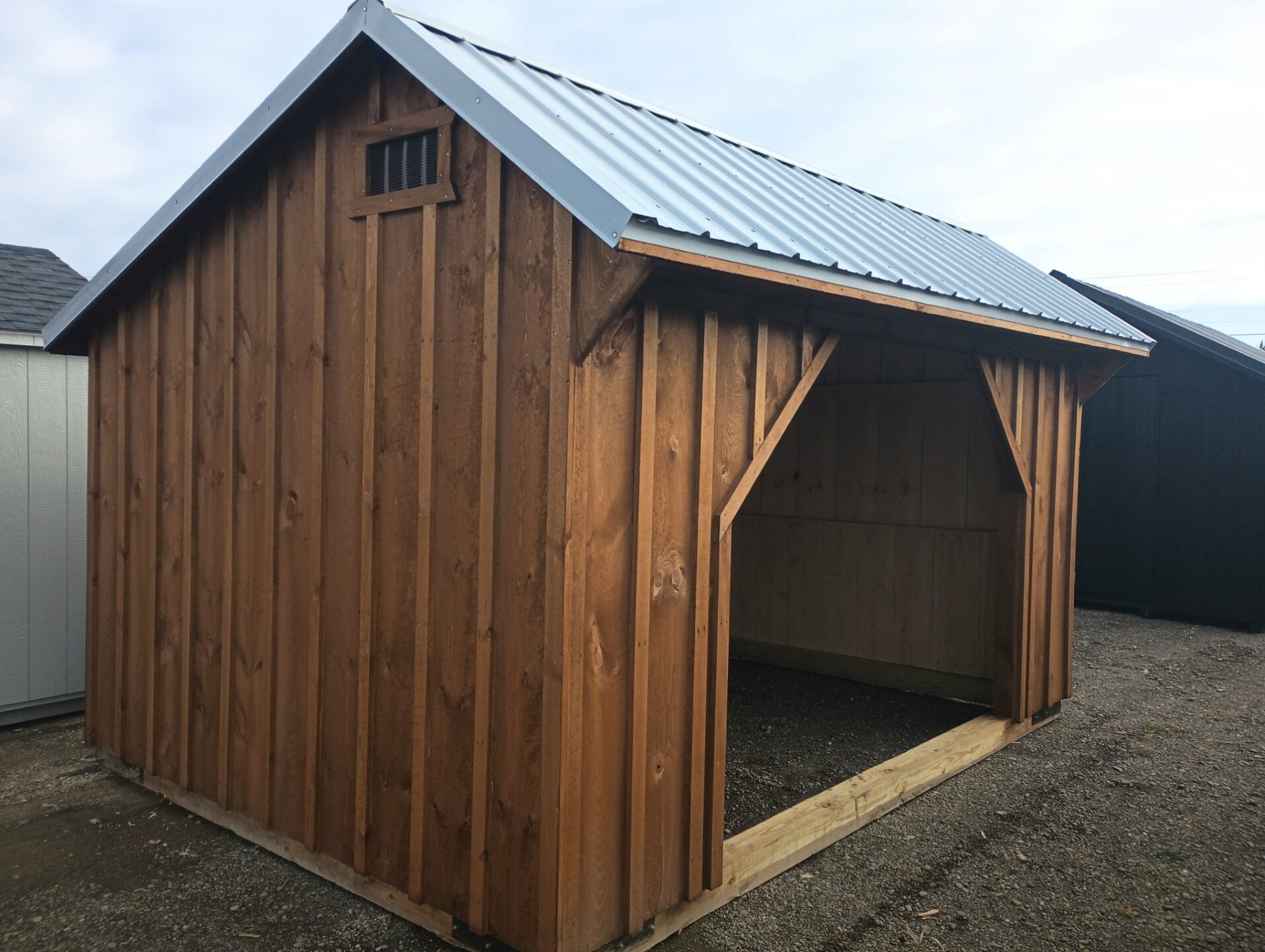 Board and batten siding with metal roof and 6x6 floorless structure